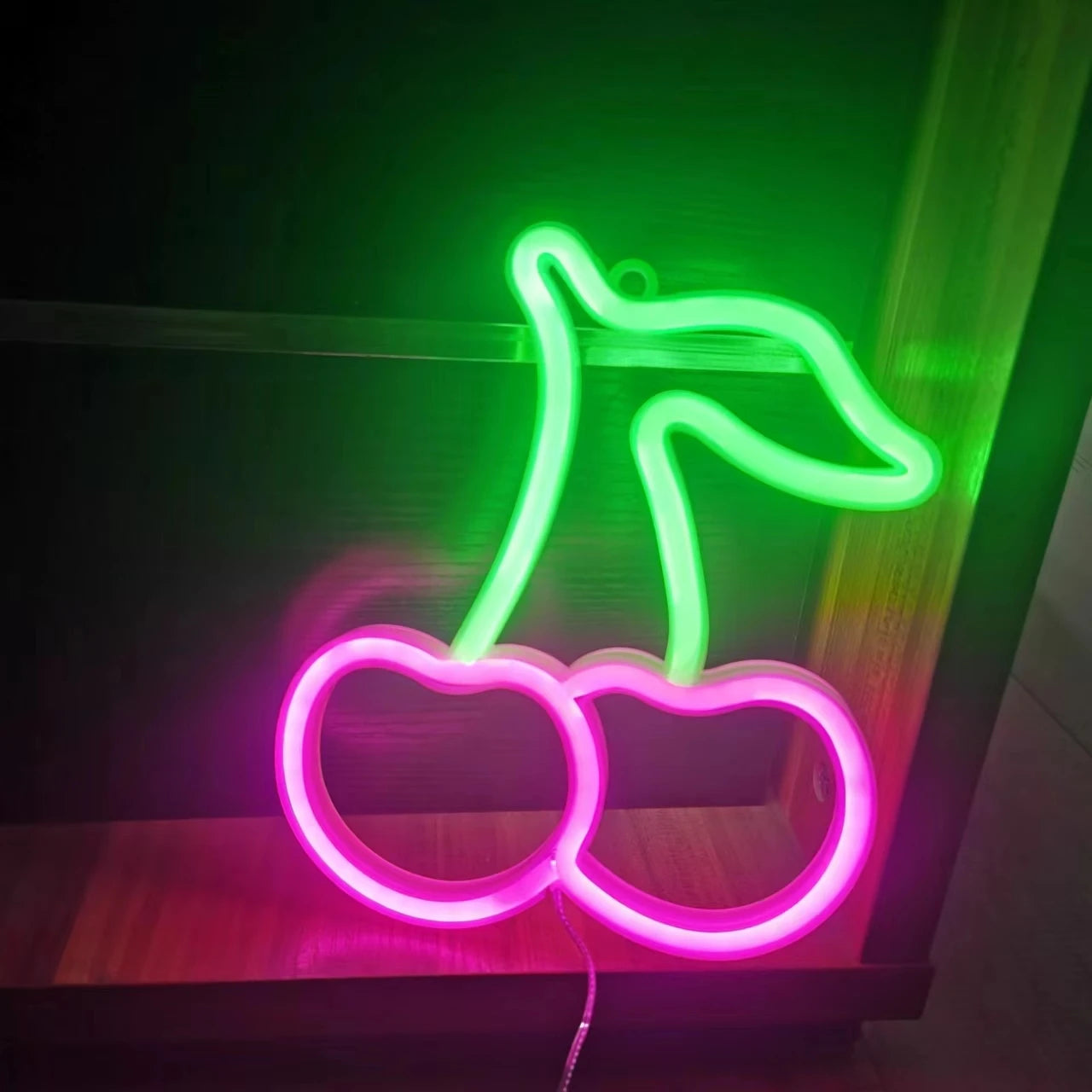 Lampe led néon décorative cerise allumé sur une étagère