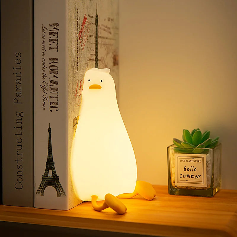 Veilleuse canard allongé et des livres