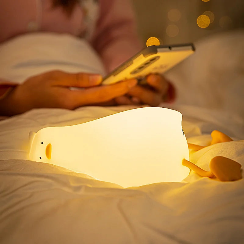 Veilleuse canard allongé sur un lit