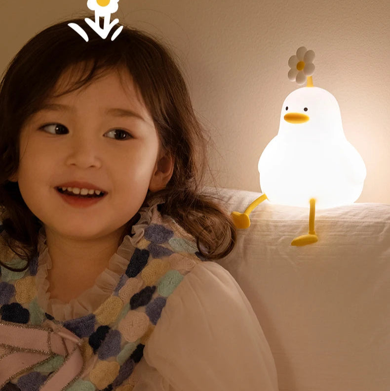 Une fille à côté d'une veilleuse LED canard allumé 