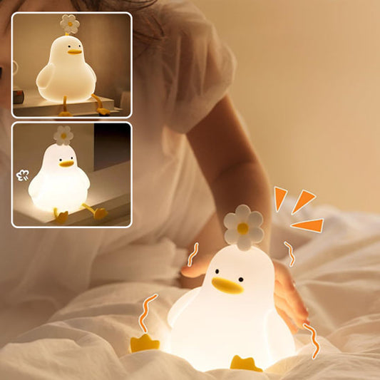 Une main qui appui sur veilleuse LED canard cute 
